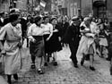 A Frenchwoman with her baby fathered by a German soldier, punished by having her head shaved after the liberation of the town, Chartres, August 18, 1944